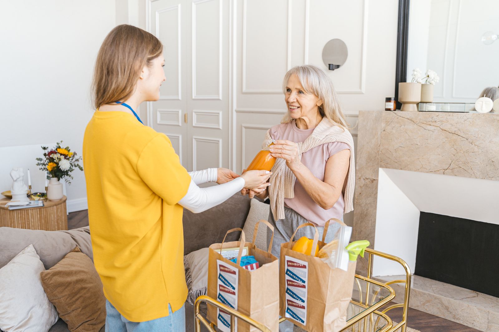 Support worker helping a senior client with groceries at home, representing Betterway Care Services person-centred NDIS support
